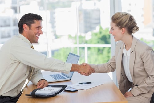 Blonde woman shaking hands while having an interview in office 2019